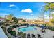 A resort-style pool surrounded by lush landscaping, lounge chairs, and residential buildings at 4173 Hibiscus Dr. # 204, Little River, SC 29566