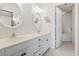 Bathroom features a double sink vanity with blue hardware and decorative round mirrors at 4396 Baldwin Ave. # 138, Little River, SC 29566