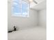 The bedroom has neutral walls and carpet, a large window letting in lots of light, and a ceiling fan at 4396 Baldwin Ave. # 138, Little River, SC 29566