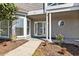 Charming front entrance with well-maintained landscaping and a welcoming doorway at 4396 Baldwin Ave. # 138, Little River, SC 29566