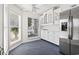 Charming kitchen nook with stainless steel refrigerator, bright windows, and custom cabinetry for a delightful dining experience at 4396 Baldwin Ave. # 138, Little River, SC 29566