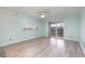 Well-lit bedroom with aqua walls, grey laminate flooring, ceiling fan and a sliding glass door at 4445 Kingsport Rd. # 406, Little River, SC 29566