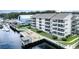 Waterfront condo building with private wooden pier, gazebo, and lounge chairs overlooking the river at 4445 Kingsport Rd. # 406, Little River, SC 29566