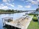 Waterfront condo pier featuring a gazebo with seating and lounge chairs near waterway at 4445 Kingsport Rd. # 406, Little River, SC 29566