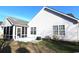 The back of the home features a screened in porch, small garden and vinyl siding at 449 Pennington Loop, Myrtle Beach, SC 29588