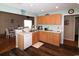 Open kitchen with wood cabinets, marble countertops, and seamless access to the dining area at 449 Pennington Loop, Myrtle Beach, SC 29588