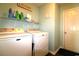 The laundry room features a washer, dryer, and shelving with cleaning supplies at 449 Pennington Loop, Myrtle Beach, SC 29588