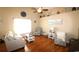 Bright living room with hardwood floors, high ceilings, ceiling fan, and beach-themed décor at 449 Pennington Loop, Myrtle Beach, SC 29588