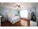 Spacious main bedroom with a tray ceiling, ceiling fan and hardwood floors and white furnishings at 449 Pennington Loop, Myrtle Beach, SC 29588