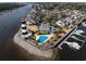 Aerial view showcasing the community pool, lighthouse, and waterfront homes with marina access at 4545 Lighthouse Dr. # 28C, Little River, SC 29566
