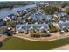 An aerial view showcases waterfront townhomes with manicured landscaping, parking, and water views at 4545 Lighthouse Dr. # 28C, Little River, SC 29566