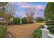 Serene backyard with lush landscaping, mature trees, and a tranquil pond view at 4545 Lighthouse Dr. # 28C, Little River, SC 29566