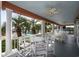 Relaxing outdoor balcony with comfortable seating, ceiling fans and tranquil waterfront views surrounded by palm trees at 4545 Lighthouse Dr. # 28C, Little River, SC 29566