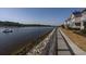 Scenic waterfront view with a sidewalk alongside modern townhomes on a sunny day at 4545 Lighthouse Dr. # 28C, Little River, SC 29566