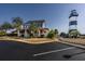 Charming waterfront home with a inviting front porch, palm trees, and a picturesque lighthouse view at 4545 Lighthouse Dr. # 28C, Little River, SC 29566