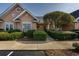 Charming home with manicured landscaping, inviting walkway, and peach stucco exterior at 4545 Lighthouse Dr. # 28C, Little River, SC 29566