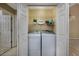 Convenient laundry room with washer, dryer, storage shelves, and a laundry-themed decor sign at 4545 Lighthouse Dr. # 28C, Little River, SC 29566