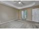 Spacious bedroom boasts a tray ceiling, neutral tones, and access to the ensuite bath at 4545 Lighthouse Dr. # 28C, Little River, SC 29566