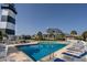 Community pool featuring inviting lounge chairs, lush palms, and views of the elegant homes at 4545 Lighthouse Dr. # 28C, Little River, SC 29566