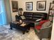 Cozy living room with a dark leather sofa, accent chair, and decorative artwork at 501 44Th Ave. N # A-11, Myrtle Beach, SC 29577