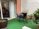 Cozy outdoor patio with artificial grass, patio furniture, and potted plants at 501 44Th Ave. N # A-11, Myrtle Beach, SC 29577
