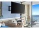 Balcony view of ocean with seating and a TV on the wall at 5523 North Ocean Blvd. # 1912, Myrtle Beach, SC 29577