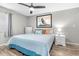 Comfortable bedroom with ceiling fan, wood flooring, nautical artwork, and soft lighting at 5523 North Ocean Blvd. # 1912, Myrtle Beach, SC 29577