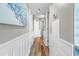 Bright hallway with wood-look flooring, white wainscoting, and stylish wall art at 5523 North Ocean Blvd. # 1912, Myrtle Beach, SC 29577