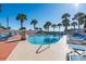 Sparkling outdoor pool surrounded by lush palm trees and comfortable lounge chairs, perfect for relaxation at 5523 North Ocean Blvd. # 1912, Myrtle Beach, SC 29577