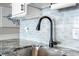 Close-up of sink with granite countertops and subway tile backsplash at 5523 North Ocean Blvd. # 1912, Myrtle Beach, SC 29577