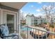 Balcony view of pool, lounging area, and nearby building with lush trees and a partially cloudy sky at 5905 South Kings Hwy. # 4219-D, Myrtle Beach, SC 29575