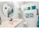 Bright bathroom with a vanity sink, decorative mirror, and artistic wall decor, creating a spa-like atmosphere at 5905 South Kings Hwy. # 4219-D, Myrtle Beach, SC 29575