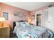 Cozy pink bedroom with a floral-patterned bedspread, inviting ambiance, and an ensuite bathroom at 5905 South Kings Hwy. # 4219-D, Myrtle Beach, SC 29575