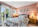 Inviting bedroom features a private balcony, soft pink walls, and tropical outdoor views at 5905 South Kings Hwy. # 4219-D, Myrtle Beach, SC 29575