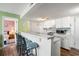 Open kitchen with breakfast bar, white cabinets, updated appliances, and seamless transition to the bedroom at 5905 South Kings Hwy. # 4219-D, Myrtle Beach, SC 29575