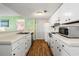 Bright kitchen with white cabinets, a sink, and stainless steel appliances, offering style and functionality at 5905 South Kings Hwy. # 4219-D, Myrtle Beach, SC 29575