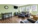 Living room with comfortable gray seating, natural light, and glimpses of outdoor scenery through the windows at 5905 South Kings Hwy. # 4219-D, Myrtle Beach, SC 29575