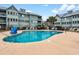 Community pool with lounge chairs and picnic tables for residents to enjoy on a sunny day at 5905 South Kings Hwy. # 4219-D, Myrtle Beach, SC 29575