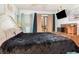 Bedroom features a plush bed with a dark quilt and an exterior view at 5905 South Kings Hwy. # 4107-D, Myrtle Beach, SC 29575
