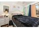 Light and airy bedroom features a plush bed with a dark-colored quilt and ample natural light at 5905 South Kings Hwy. # 4107-D, Myrtle Beach, SC 29575
