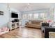 Cozy living room with wood floors, a ceiling fan, and multiple windows providing ample natural light at 5905 South Kings Hwy. # 4107-D, Myrtle Beach, SC 29575