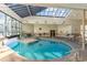 Indoor pool area with a skylight, tables, chairs, and lounge area at 5905 South Kings Hwy. # 4107-D, Myrtle Beach, SC 29575