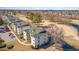 Aerial shot of multi-story buildings beside a golf course and pond with a tree in center view at 597 Blue River Ct. # H2, Myrtle Beach, SC 29579