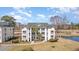 Scenic aerial view showcasing the condo, pond, golf course, and lush green surroundings at 597 Blue River Ct. # H2, Myrtle Beach, SC 29579