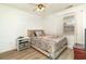 Cozy bedroom with a comfortable bed, ceiling fan, and window providing natural light at 597 Blue River Ct. # H2, Myrtle Beach, SC 29579