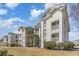Attractive condo complex showcasing multiple stories, private balconies, and well-manicured green spaces at 597 Blue River Ct. # H2, Myrtle Beach, SC 29579