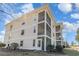 Multi-story building featuring screened-in patios, offering a blend of indoor/outdoor living at 597 Blue River Ct. # H2, Myrtle Beach, SC 29579