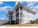 Charming multi-story building with screened-in patios and scenic water views at 597 Blue River Ct. # H2, Myrtle Beach, SC 29579