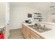 Bright kitchen with stainless sink, white cabinets, and a serving counter to the living area at 597 Blue River Ct. # H2, Myrtle Beach, SC 29579
