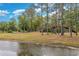 Scenic pond view with a wooden bridge and lush trees in a vibrant community park at 597 Blue River Ct. # H2, Myrtle Beach, SC 29579